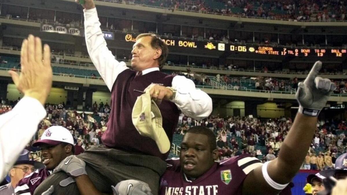 Mississippi State head coach Jackie Sherrill celebrates the Bulldogs 17-7 Peach Bowl victory over Clemson on the shoulders of Eric Thompson (78) and Derrick Thompson (65) at the Georgia Dome in Atlanta Thursday, Dec. 30, 1999.