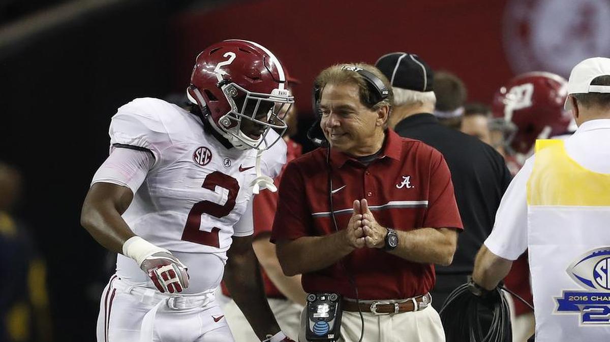 Alabama quarterback Jalen Hurts speaks with Alabama head coach Nick Saban during the SEC title game against Florida in Atlanta.