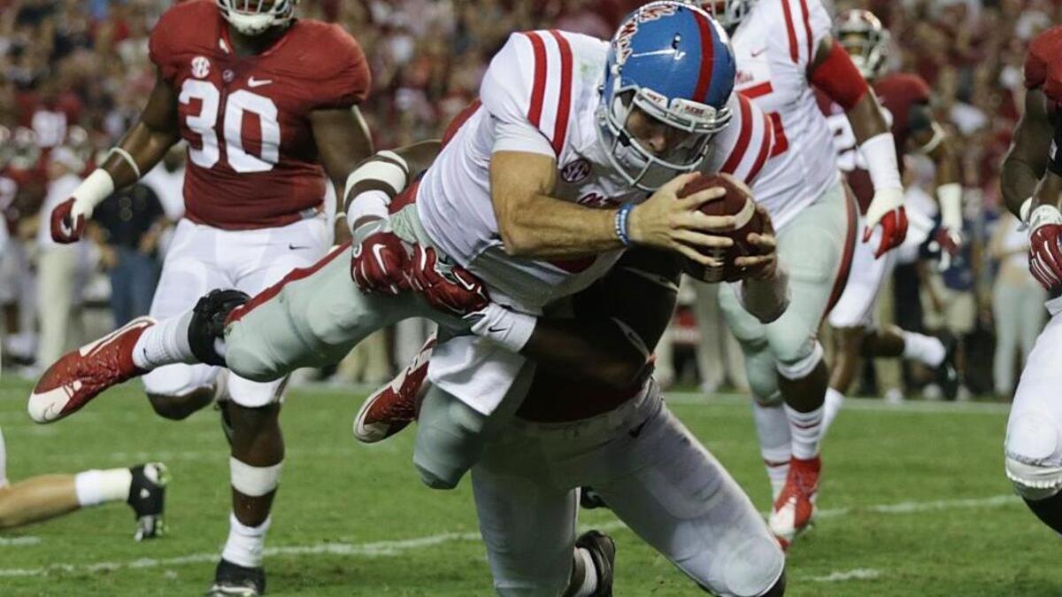 Ole Miss quarterback Chad Kelly dives in for a touchdown against Alabama linebacker Shaun Hamilton on Sept. 19, 2015, in Tuscaloosa, Alabama. Kelly was the last pick in the NFL Draft by the Denver Broncos. He’ll need the shake the “Mr. Irrelevant” tag if he wants to make a career in the NFL.