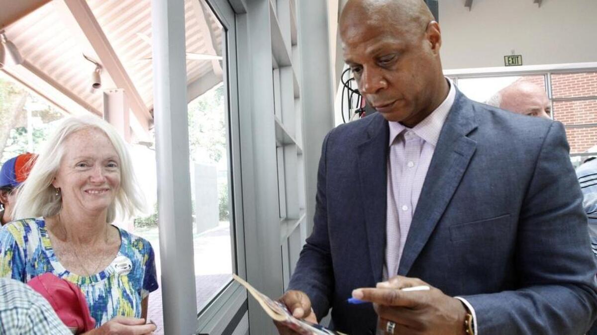 Darryl Strawberry signs memorabilia after his talk at Our Love Affair With Baseball at the Ohr-O'Keefe Museum of Art.