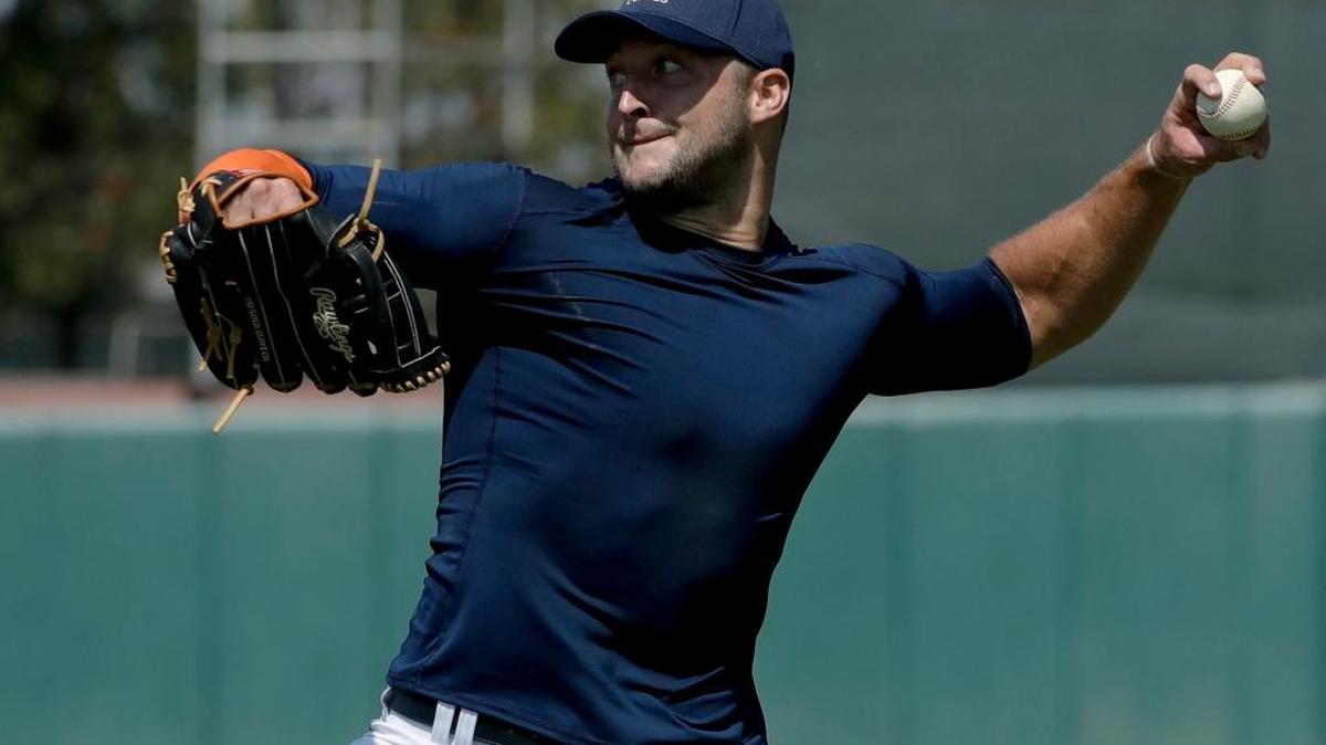 Former NFL quarterback, Tim Tebow throws a ball for baseball scouts and the media during a showcase on the campus of the University of Southern California, Tuesday, Aug. 30, 2016 in Los Angeles. The Heisman Trophy winner works out for a big gathering of scouts on USC's campus in an attempt to start a career in a sport he hasn't played regularly since high school.