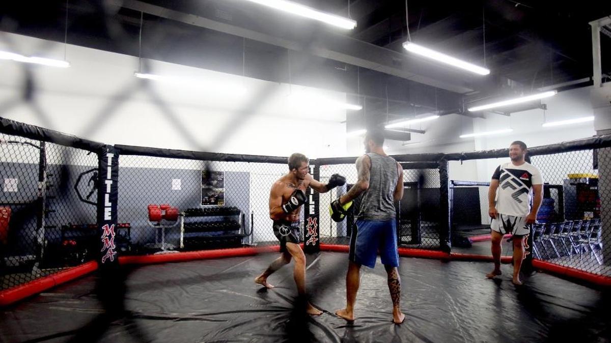 UFC featherweight Jason Knight, left, trains with his striking coach Brandon Davis, center, while coach James Sharp watches his form on Thursday, July 6, 2017, at Alan Belcher MMA Club in D'Ibeville. Knight will face top five featherweight Ricardo Lamas on July 29 at the Honda Center in Anaheim, Calif.