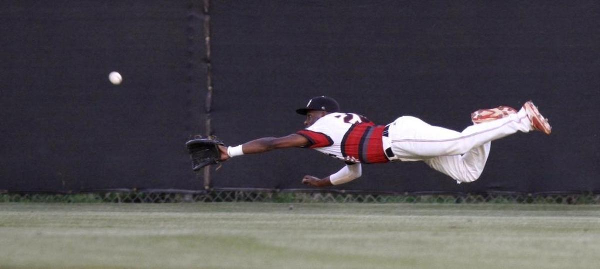Harrison Central center fielder D’Artagnan Hawthorne can’t make a diving catch as Gulfport jumped out to an early two-run lead. Photographer’s comment: I absolutely love to shoot baseball games. I usually will volunteer to cover the games. This game was a pitcher’s duel with very little hitting. I was able to get a nice image of Harrison Central’s center fielder diving after a shot to the fence.