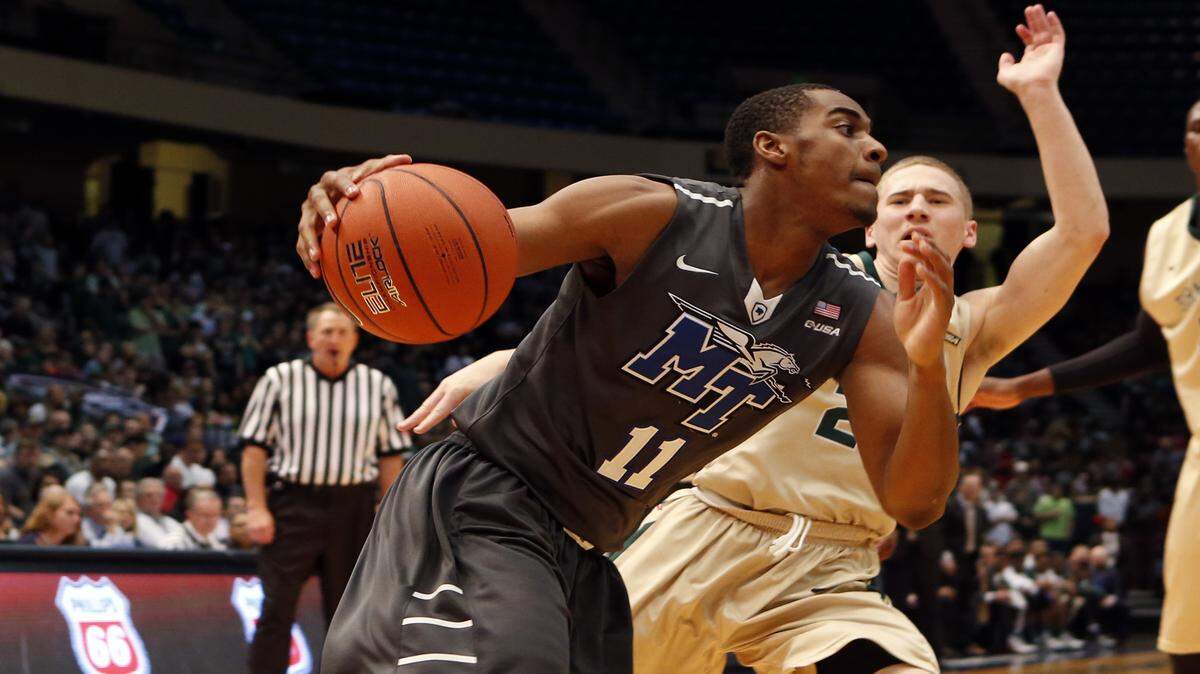 BUTCH DILL/ASSOCIATED PRESS
Middle Tennessee guard Edward Simpson Jr. (11) drives the baseline around UAB guard Nick Norton (2) during the 2015 Conference USA Tournament in Birmingham. Simpson sad out the 2016 C-USA Tournament with a broken ankle, but the Blue Raiders still managed to win the title. 