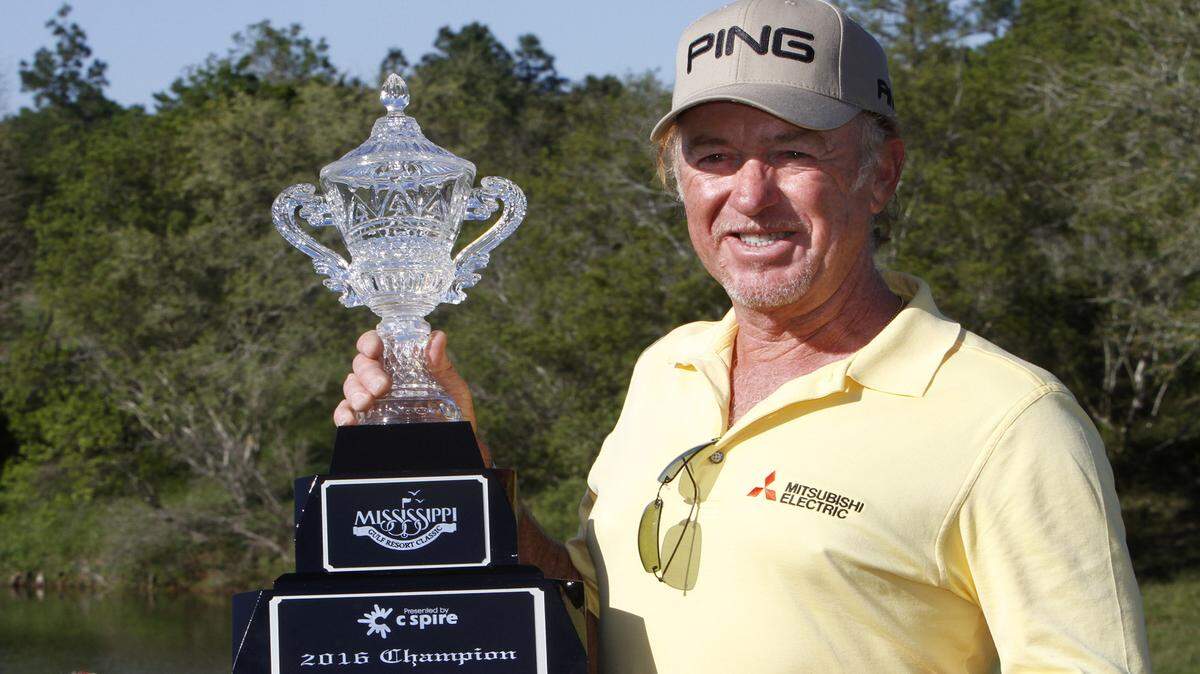 Miguel Jimenez holds the trophy after winning the Mississippi Gulf Resort Classic at Fallen Oak, Sunday, Apr. 3, 2016.