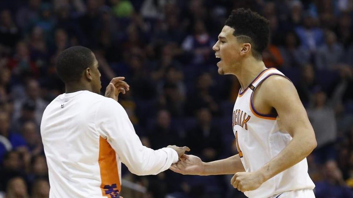 Phoenix Suns guard Devin Booker, right, celebrates his score with guard Isaiah Canaan, left, during the second half of a game against the Memphis Grizzlies on Dec. 26 in Phoenix.