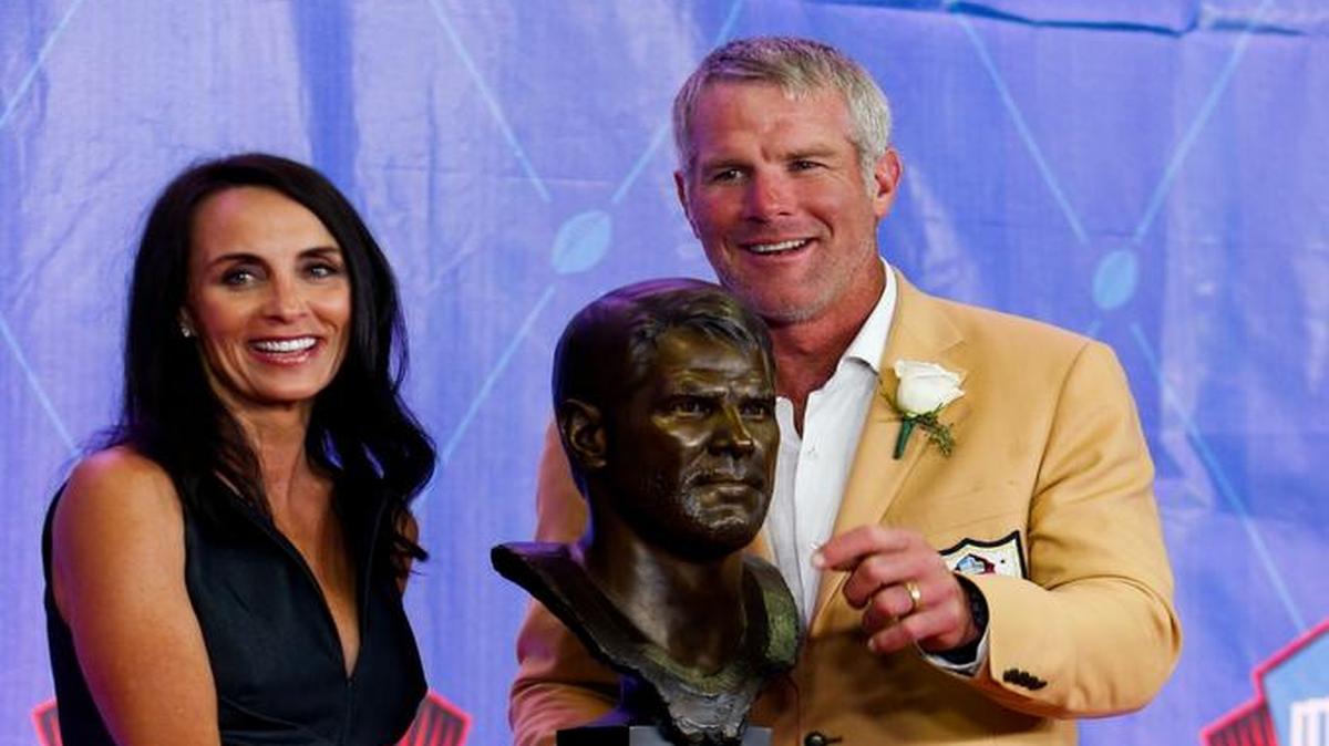 Former NFL player Brett Favre and his wife Deanna pose with his bust during an induction ceremony at the Pro Football Hall of Fame Saturday in Canton, Ohio.